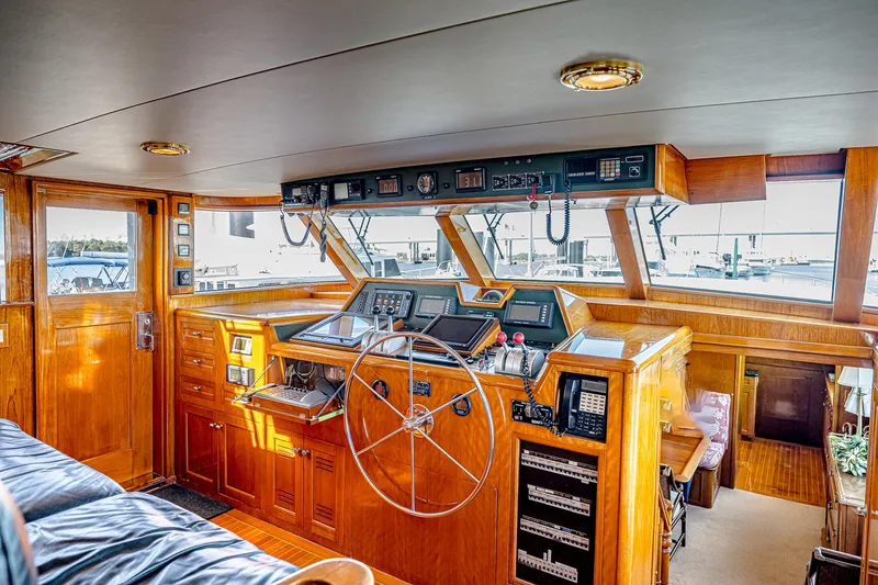 Diday Yacht Photos Pics Helm of 1984 Burger 91 yacht with wooden interior and navigation equipment.