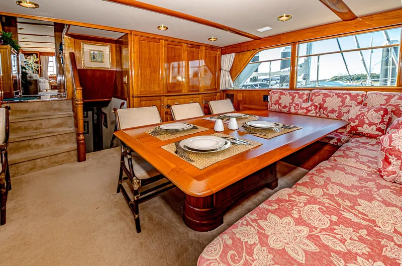 Diday Yacht Photos Pics Luxurious dining area on a 1984 Burger 91 yacht with elegant wood paneling.