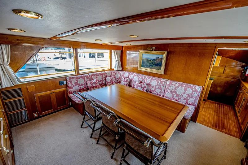 Diday Yacht Photos Pics Luxurious 1984 Burger 91 yacht interior with elegant dining area and wooden furnishings.