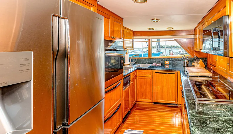 Diday Yacht Photos Pics Luxurious yacht kitchen with stainless steel appliances and wooden cabinetry, 1984 Burger 91 model.