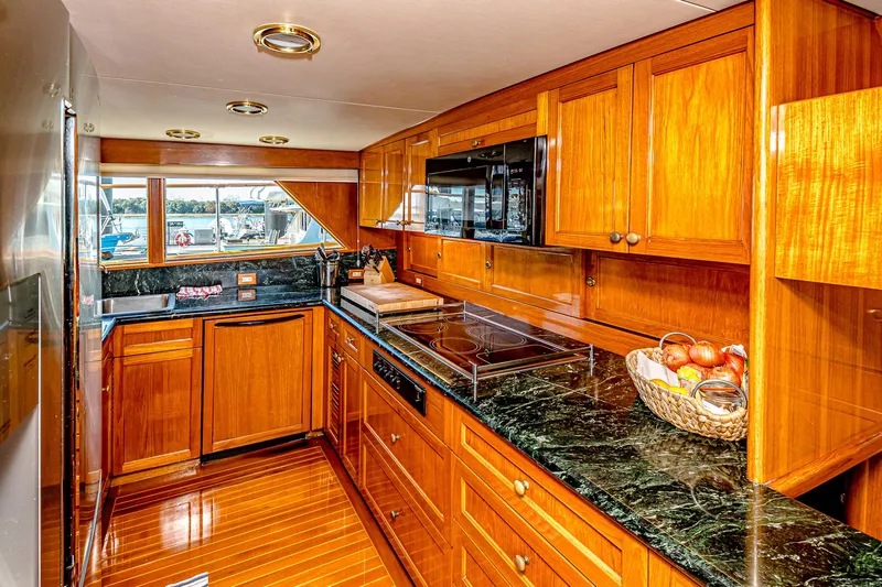 Diday Yacht Photos Pics Luxurious wooden kitchen interior on a 1984 Burger 91 yacht with modern appliances.