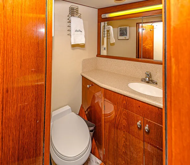 Diday Yacht Photos Pics Luxurious yacht bathroom with wooden cabinets, modern fixtures, and elegant lighting, 1984 Burger 91 model.