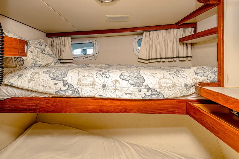 Diday Yacht Photos Pics Cozy bunk beds in a 1984 Burger 91 yacht cabin with nautical-themed bedding.