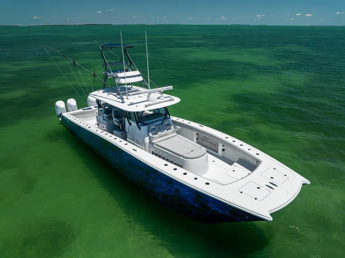  Yacht Photos Pics 2021 Freeman 42 LR boat on clear green water, featuring dual engines and fishing equipment.