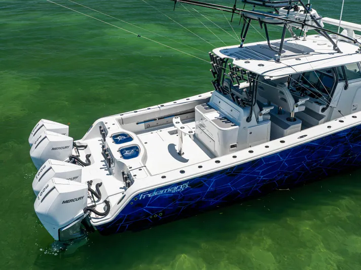  Yacht Photos Pics Freeman 42 LR 2021 boat with Mercury engines on clear green water.