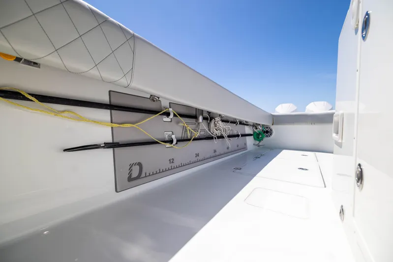  Yacht Photos Pics Interior view of a 2021 Freeman 42 LR boat, featuring fishing rod holders and a measuring ruler.