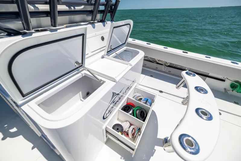  Yacht Photos Pics Fishing setup on a 2021 Freeman 42 LR boat with open storage compartments.
