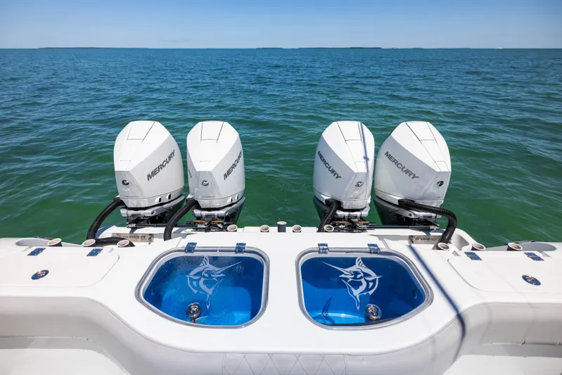  Yacht Photos Pics Four Mercury outboard engines on a 2021 Freeman 42 LR boat, ocean backdrop.