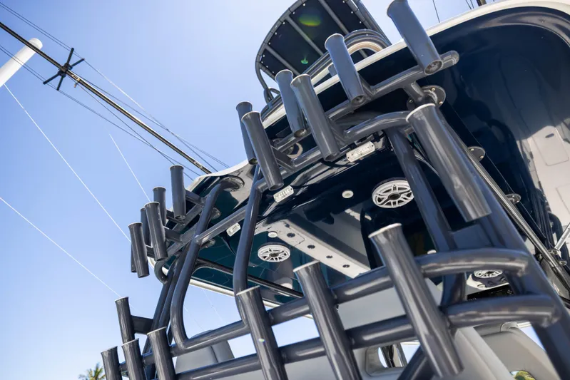  Yacht Photos Pics 2021 Freeman 42 LR boat with rod holders and speakers, viewed from below against blue sky.