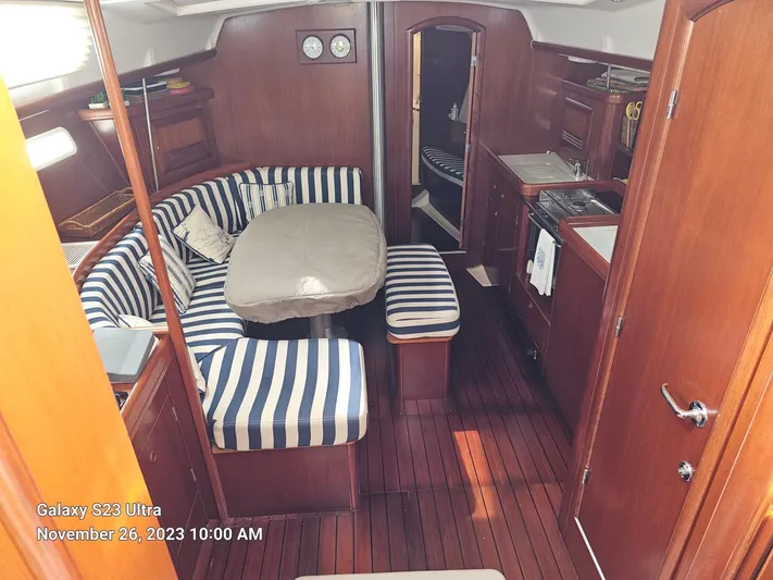  Yacht Photos Pics Interior of 2001 Beneteau Oceanis Clipper 393 with striped seating and wooden finishes.