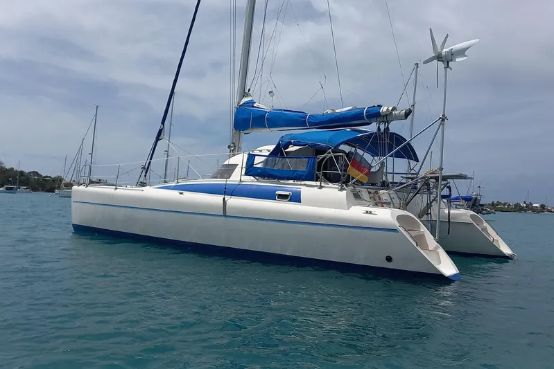 Dreamteam Yacht Photos Pics 1993 Fountaine Pajot Antigua 37 catamaran anchored in calm blue waters.