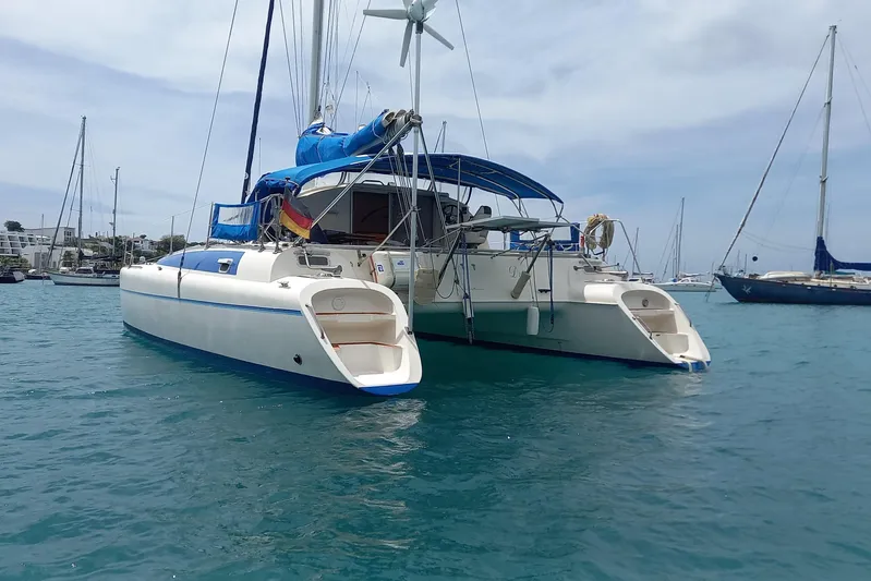 Dreamteam Yacht Photos Pics 1993 Fountaine Pajot Antigua 37 catamaran anchored in a marina, with clear blue water.