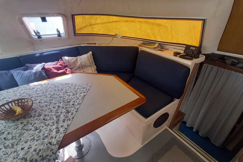 Dreamteam Yacht Photos Pics Cozy interior of 1993 Fountaine Pajot Antigua 37 catamaran with seating and table.