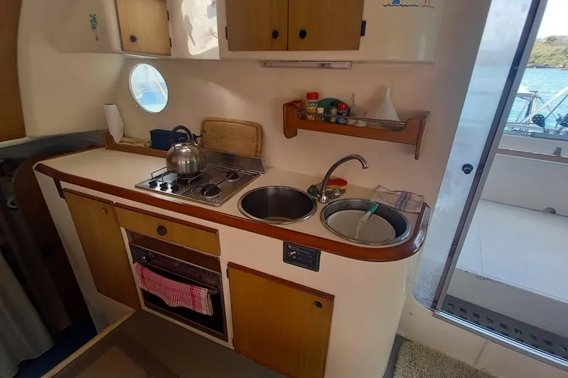 Dreamteam Yacht Photos Pics 1993 Fountaine Pajot Antigua 37 yacht kitchen with stove, sink, and storage.