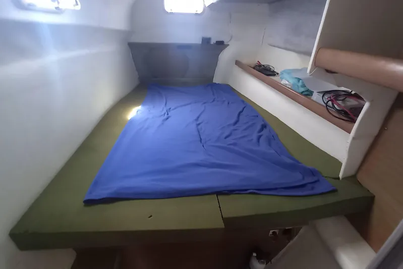 Dreamteam Yacht Photos Pics 1993 Fountaine Pajot Antigua 37 cabin interior with blue bedding and storage shelves.