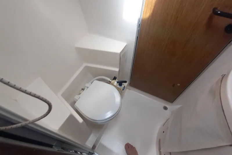 Dreamteam Yacht Photos Pics Bathroom interior of 1993 Fountaine Pajot Antigua 37 catamaran, featuring compact toilet and shower.