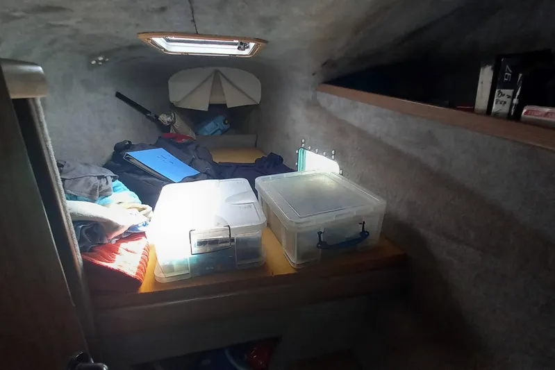 Dreamteam Yacht Photos Pics Cozy cabin interior of 1993 Fountaine Pajot Antigua 37 with storage boxes and personal items.