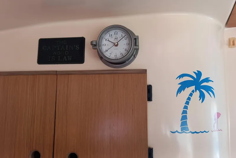 Dreamteam Yacht Photos Pics Interior of 1993 Fountaine Pajot Antigua 37 with clock, sign, and palm tree decal.