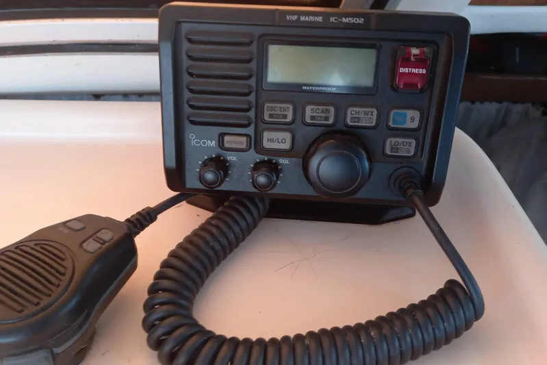 Dreamteam Yacht Photos Pics VHF marine radio on 1993 Fountaine Pajot Antigua 37 catamaran, featuring distress button and microphone.