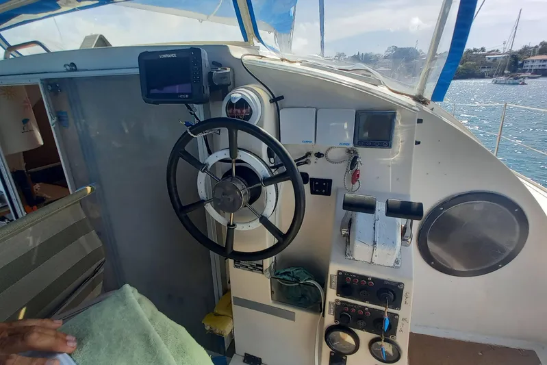 Dreamteam Yacht Photos Pics Cockpit of 1993 Fountaine Pajot Antigua 37 catamaran with steering wheel and navigation equipment.