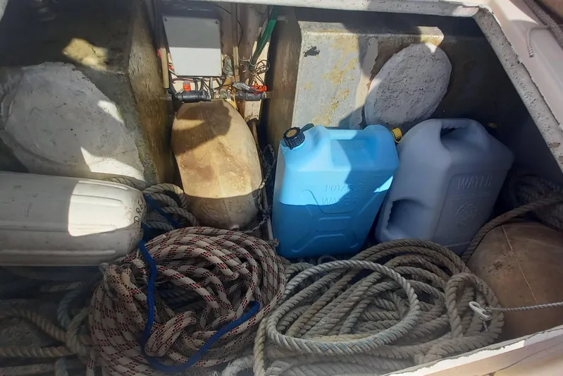 Dreamteam Yacht Photos Pics Storage compartment of 1993 Fountaine Pajot Antigua 37 with ropes and water containers.