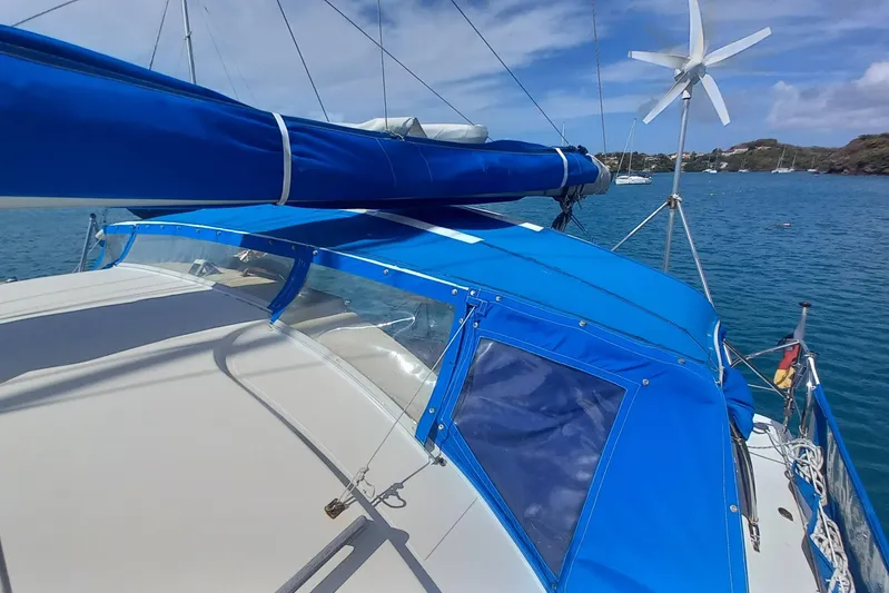 Dreamteam Yacht Photos Pics 1993 Fountaine Pajot Antigua 37 sailboat with blue canopy on calm water.