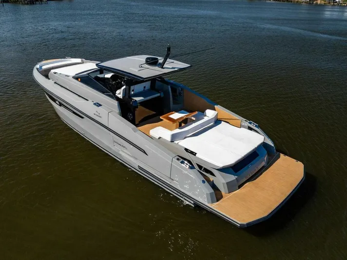  Yacht Photos Pics 2024 Rio Yachts Daytona 50 luxury yacht on calm water, showcasing sleek design and spacious deck.