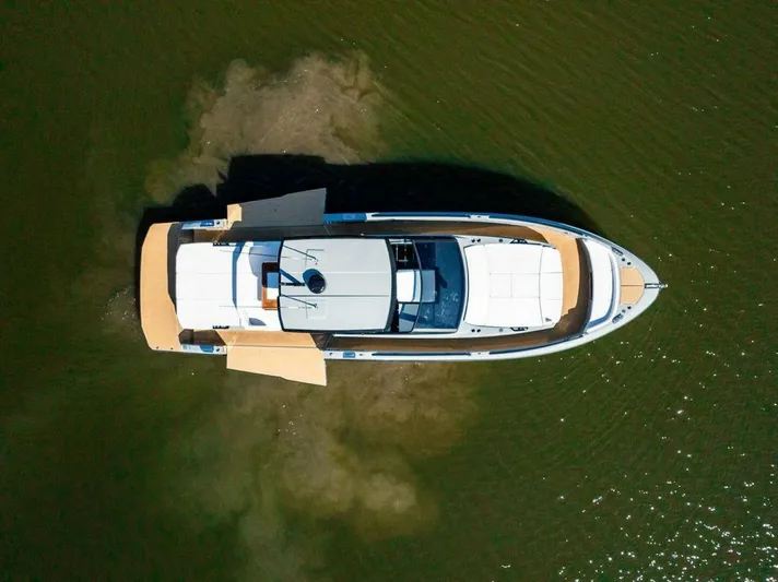  Yacht Photos Pics 2024 Rio Yachts Daytona 50, aerial view, sleek design on calm water.