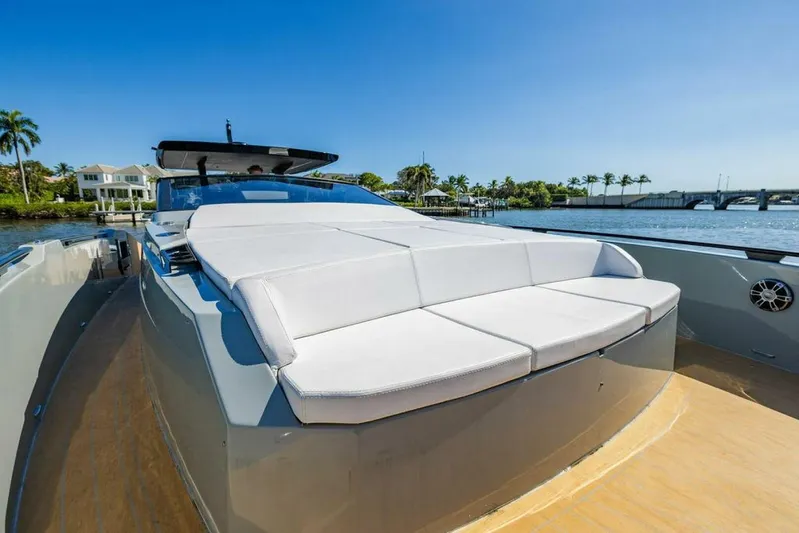  Yacht Photos Pics 2024 Rio Yachts Daytona 50 luxury yacht with spacious sun deck, docked by waterfront homes.