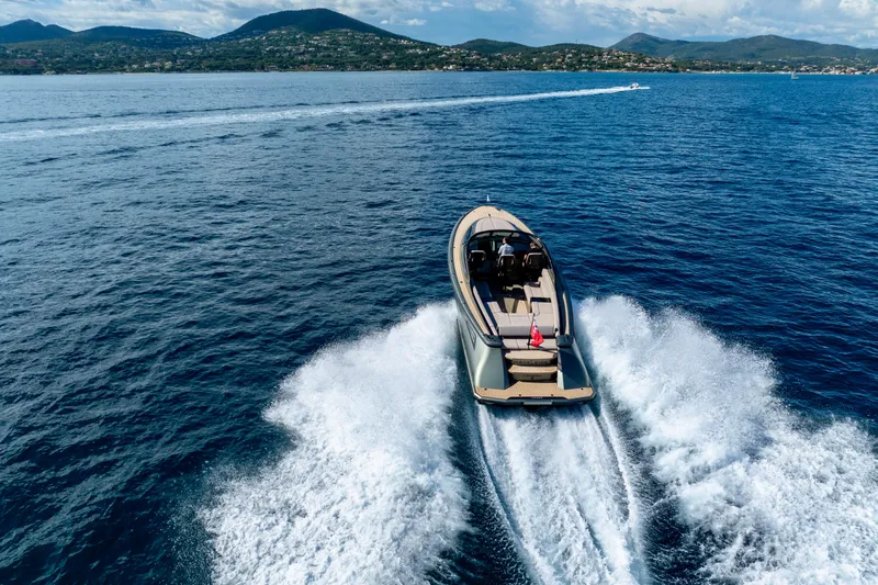 Madeleine Yacht Photos Pics 2024 Wajer 38 yacht cruising on open sea with scenic mountain backdrop.