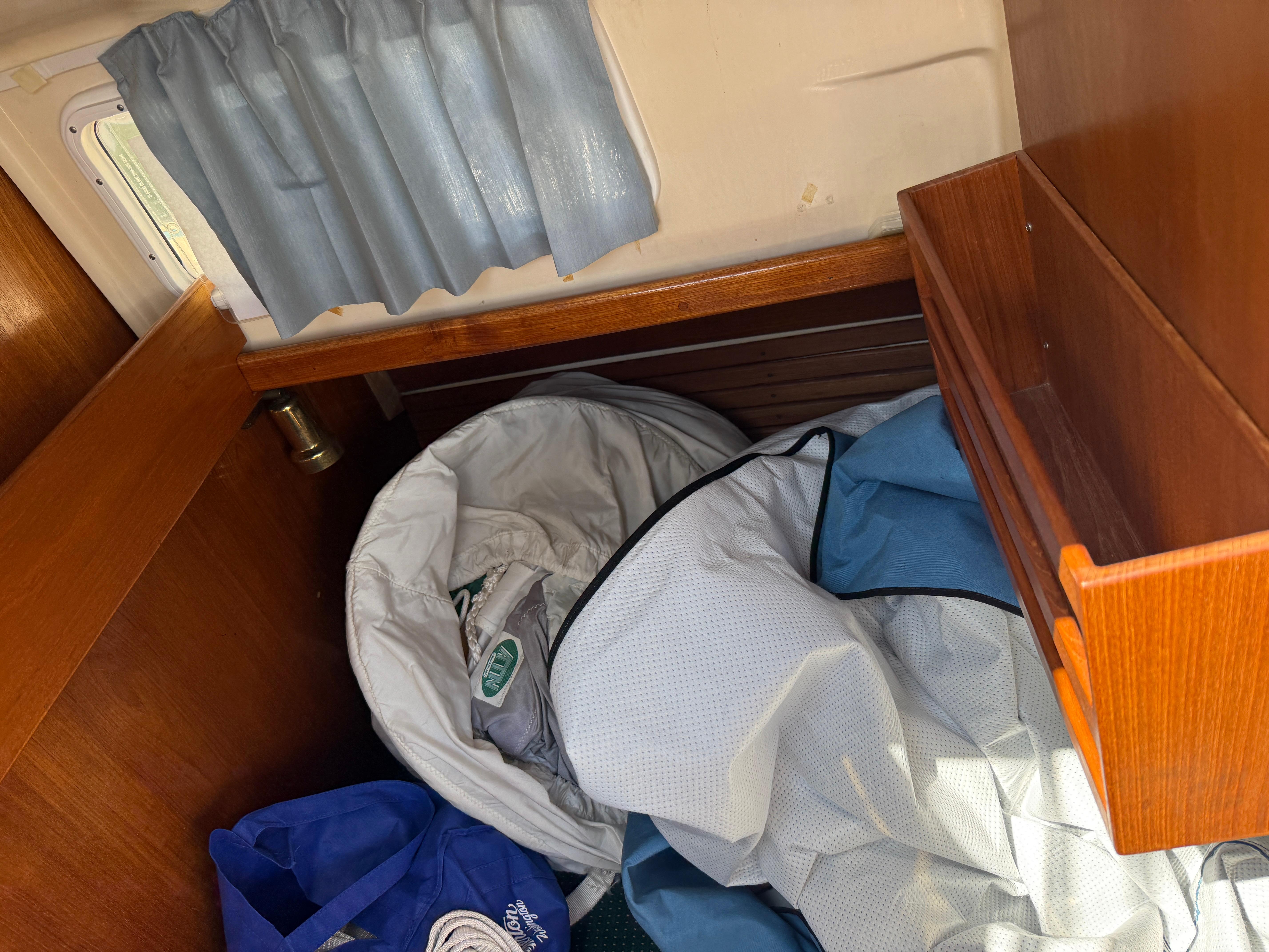 Interior of 1984 Aloha 32 sailboat with storage area and nautical gear.