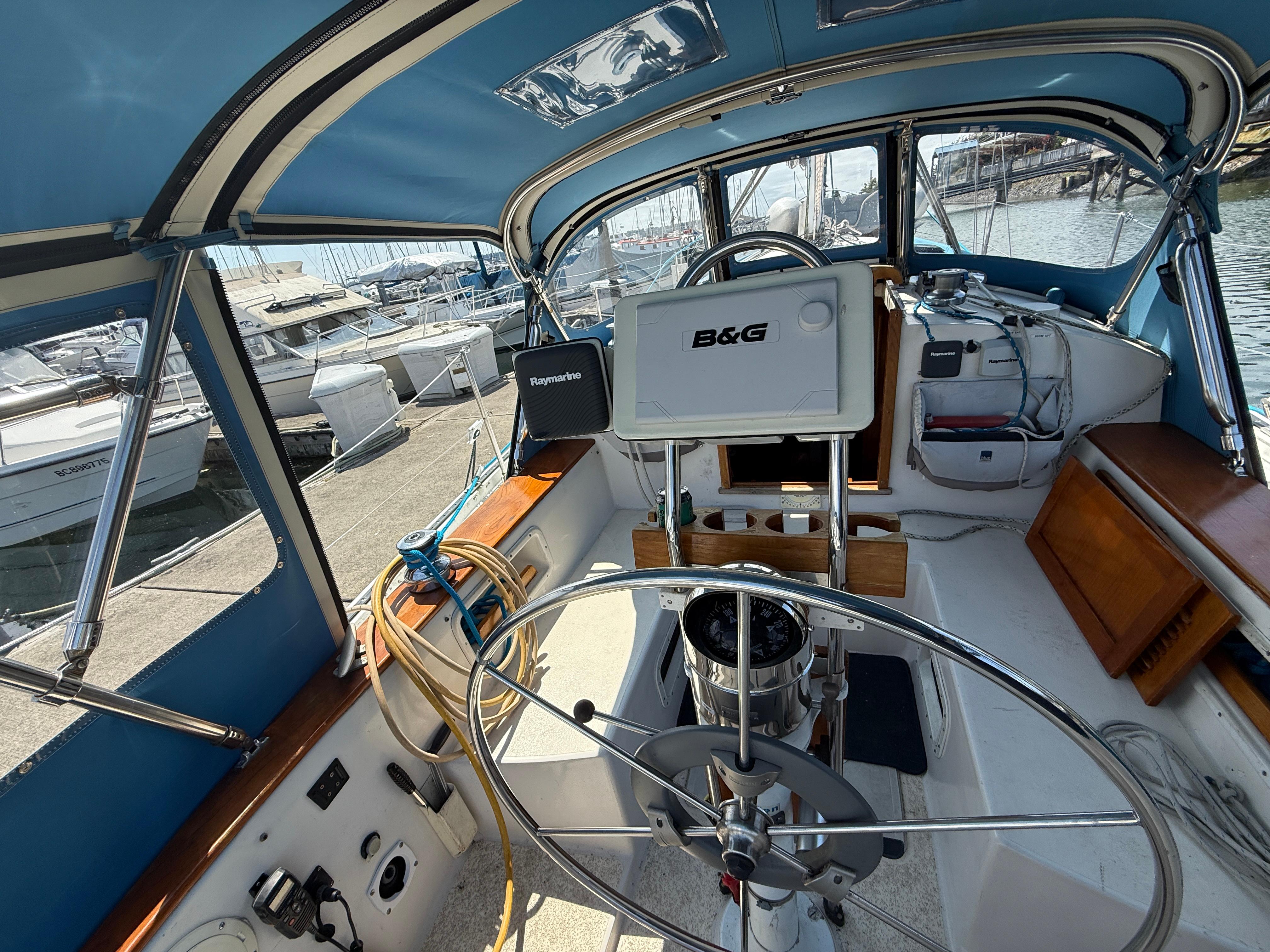 Interior view of a 1984 Aloha 32 sailboat cockpit with navigation equipment.