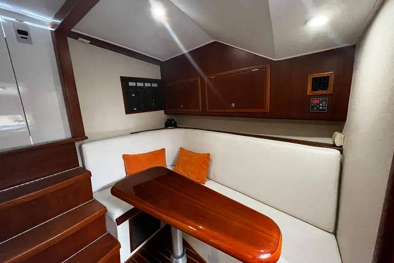  Yacht Photos Pics Interior of 2010 Scopinich 35 EXPRESS with wooden table and white seating.