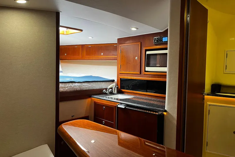  Yacht Photos Pics Luxurious interior of 2010 Scopinich 35 EXPRESS yacht with kitchenette and cozy sleeping area.