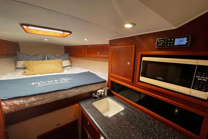  Yacht Photos Pics 2010 Scopinich 35 EXPRESS cabin interior with bed, microwave, and sink.