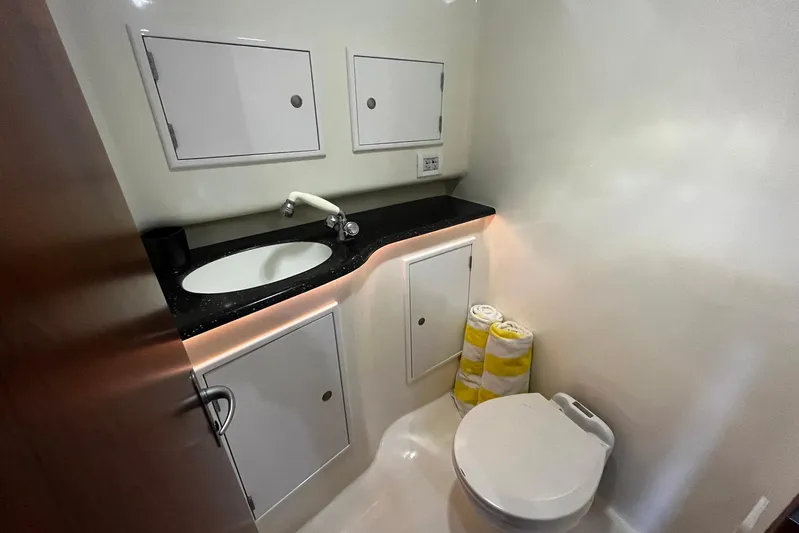  Yacht Photos Pics 2010 Scopinich 35 EXPRESS yacht bathroom with sink, storage cabinets, and toilet.