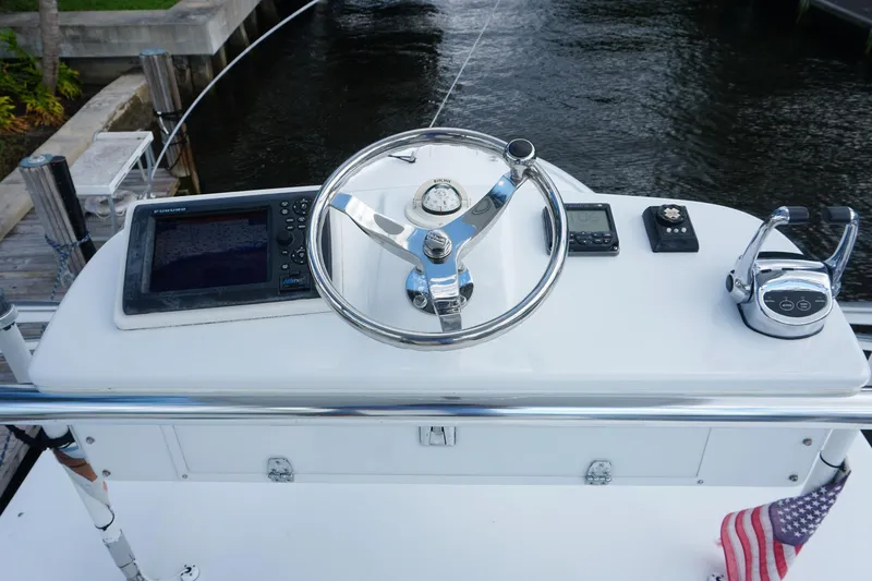  Yacht Photos Pics Helm of 2010 Scopinich 35 EXPRESS with navigation equipment and steering wheel.