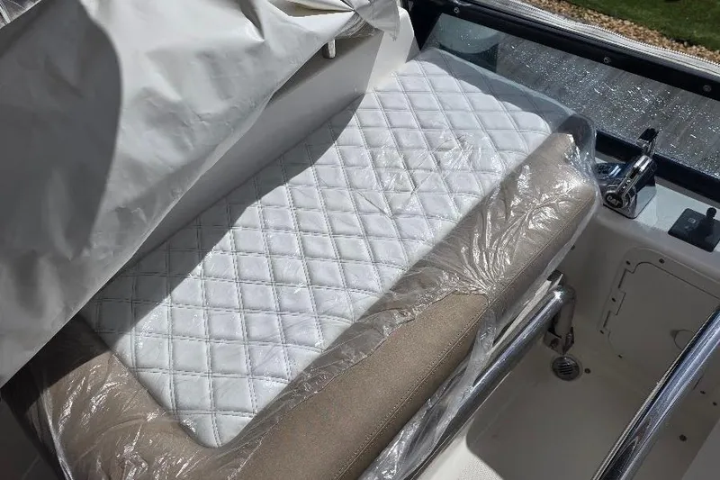 Blue Bird Yacht Photos Pics Luxurious seating on 2008 Neptunus Flybridge MY, featuring quilted white upholstery.