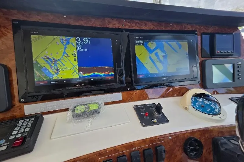 Blue Bird Yacht Photos Pics Control panel of 2008 Neptunus Flybridge MY with navigation screens and instruments.