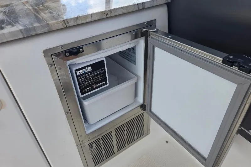 Blue Bird Yacht Photos Pics Open ice maker on 2008 Neptunus Flybridge MY yacht, featuring stainless steel finish.