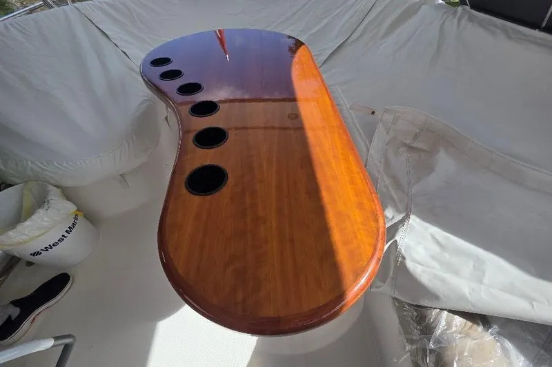 Blue Bird Yacht Photos Pics Polished wooden table with cup holders on 2008 Neptunus Flybridge MY yacht.