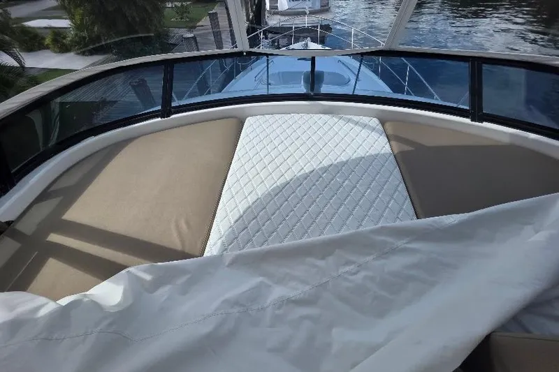 Blue Bird Yacht Photos Pics Flybridge view of 2008 Neptunus yacht with cushioned seating and water backdrop.