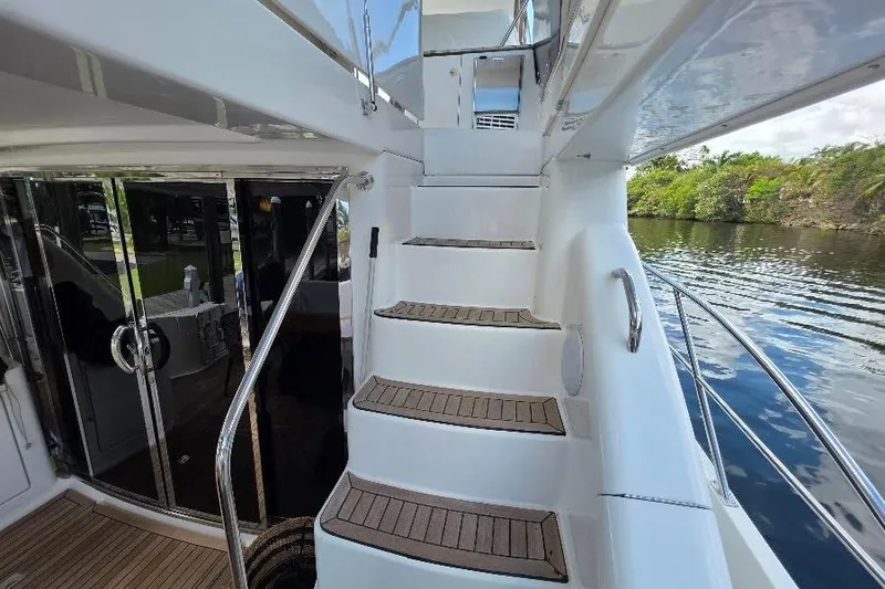 Blue Bird Yacht Photos Pics Staircase on 2008 Neptunus Flybridge MY yacht, leading to upper deck with water view.