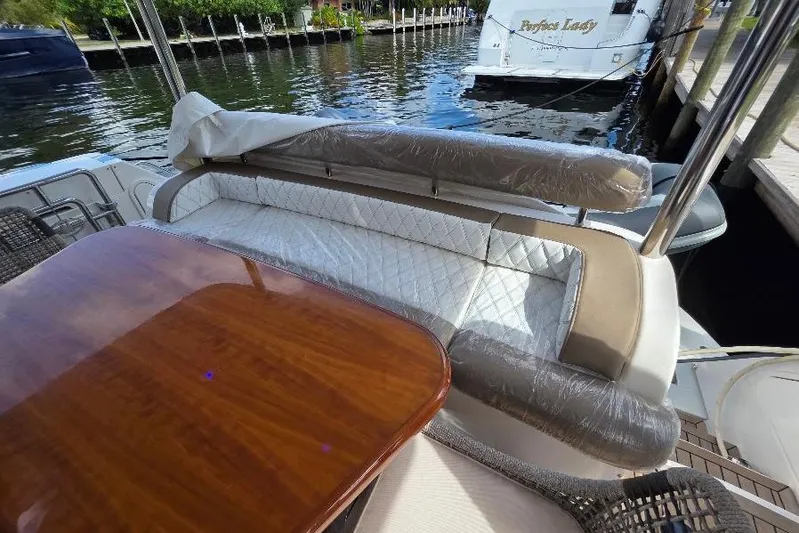 Blue Bird Yacht Photos Pics Luxurious seating area on a 2008 Neptunus Flybridge MY yacht, docked by the water.