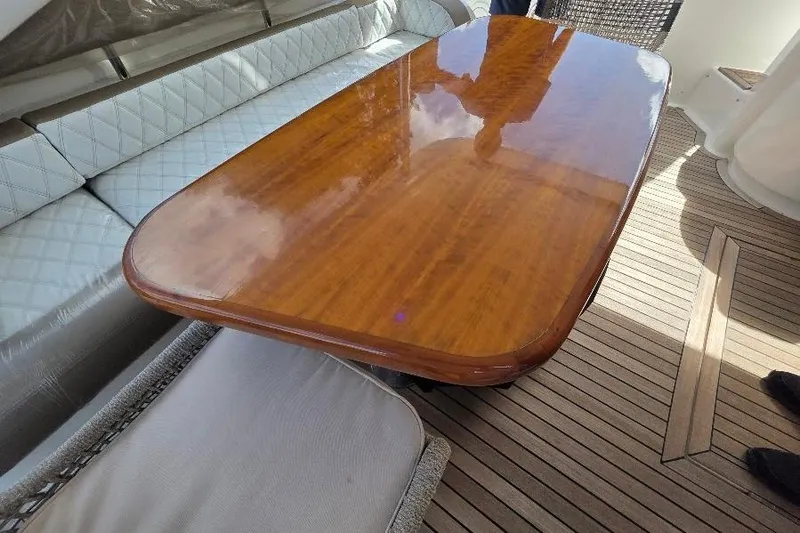 Blue Bird Yacht Photos Pics Luxurious wooden table on 2008 Neptunus Flybridge MY yacht deck.