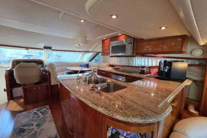 Blue Bird Yacht Photos Pics Luxurious 2008 Neptunus Flybridge MY yacht interior with modern kitchen and seating area.