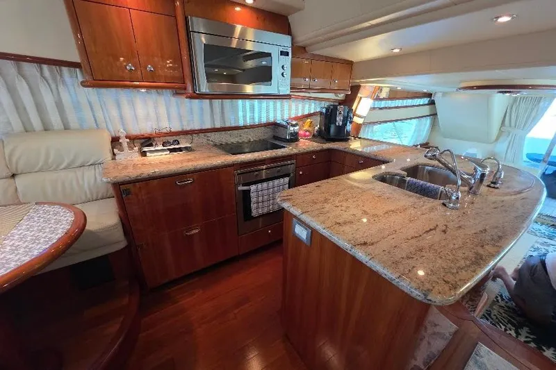 Blue Bird Yacht Photos Pics Luxurious kitchen interior of 2008 Neptunus Flybridge MY yacht with granite countertops.