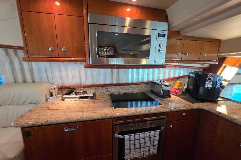 Blue Bird Yacht Photos Pics Luxurious kitchen interior of 2008 Neptunus Flybridge MY yacht with modern appliances.