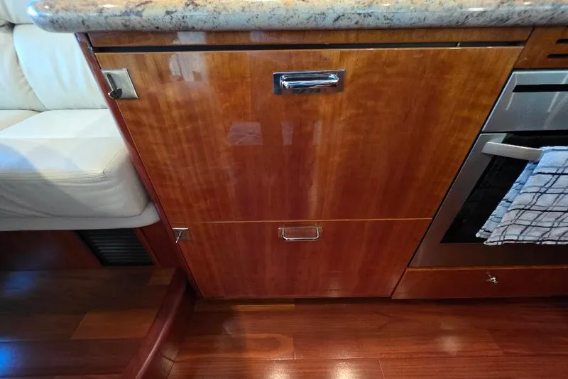 Blue Bird Yacht Photos Pics Wooden cabinetry and granite countertop in 2008 Neptunus Flybridge MY yacht kitchen.