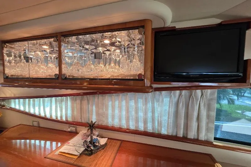 Blue Bird Yacht Photos Pics Luxurious interior of 2008 Neptunus Flybridge MY yacht with glassware and TV.